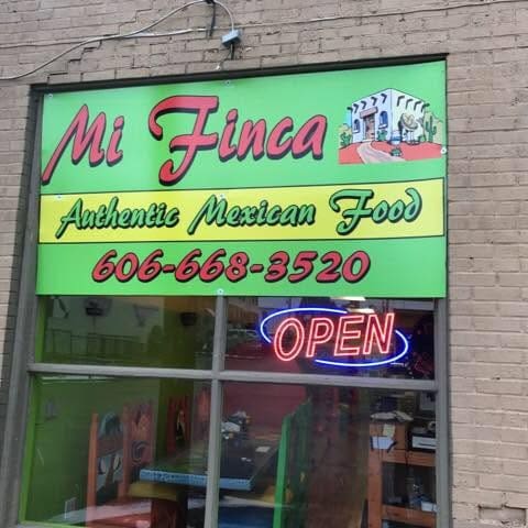 Bright green storefront sign for Mi Finca Authentic Mexican Food with phone number 606-668-3520 and a neon OPEN sign visible in the window.